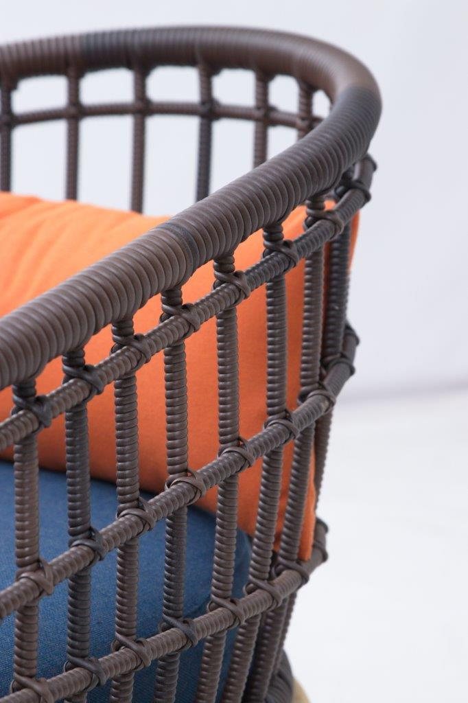 Woven outdoor armchair with cushions