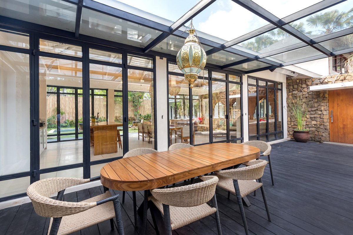 Oval timber dining table with woven chairs