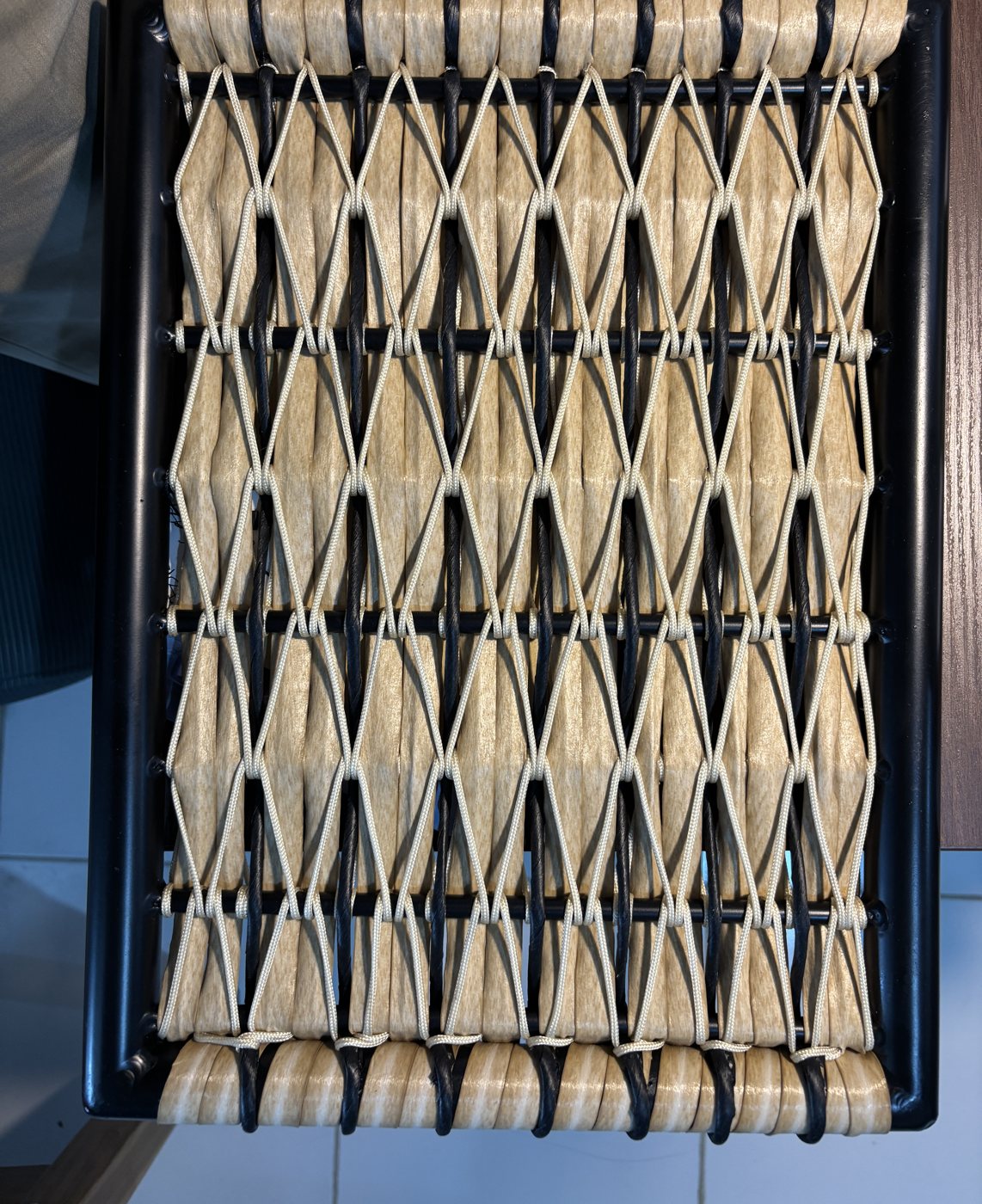 Diamond-pattern weave on a black seat frame