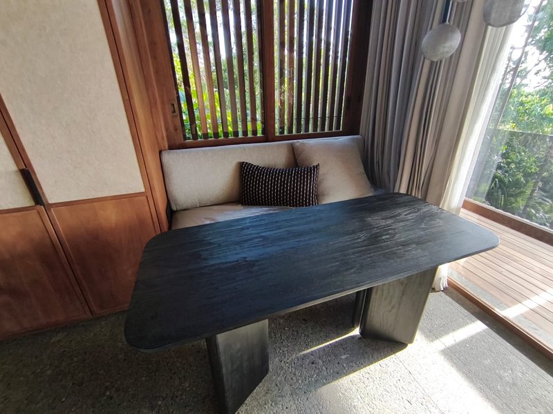 Dark-stained solid timber dining table
